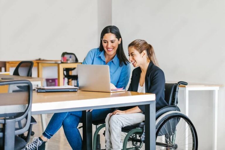 A participant and support professional reviewing information together
